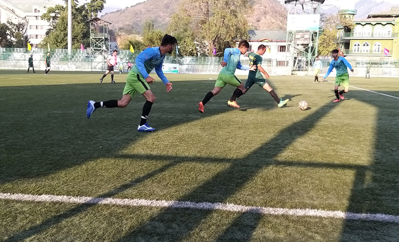 Players in action during a Football match at TRC Ground Srinagar on Monday.
