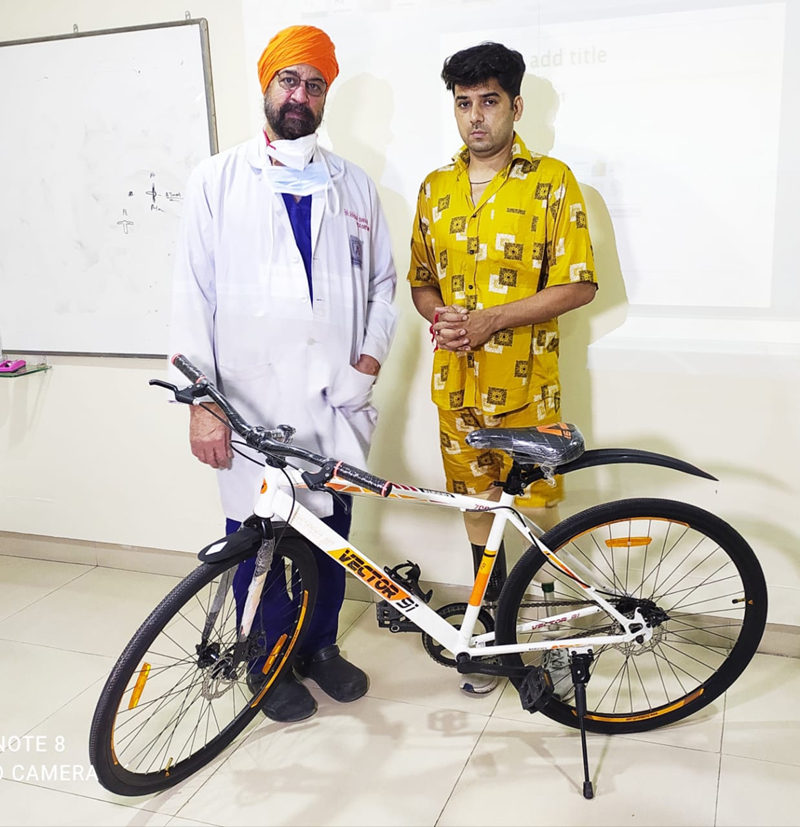 Dr Avtar Singh posing with his patient to whom he donated a bicycle. Dr Avtar Singh posing with his patient to whom he donated a bicycle.