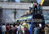After fleeing from Kashmir, migrant workers boarding a bus at Jammu to reach their home State. -Excelsior/Rakesh