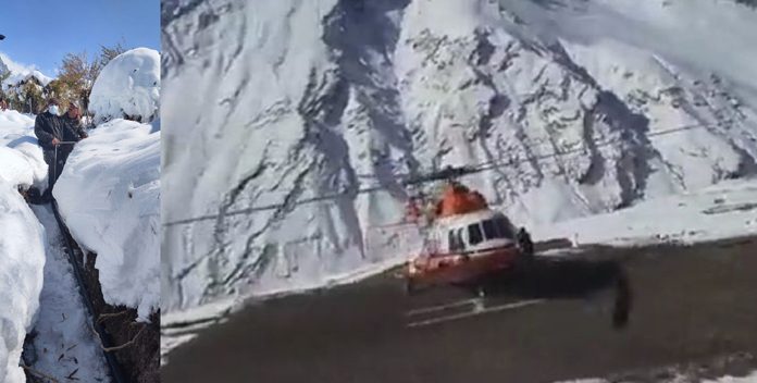 Water supply pipes being laid in snow bound area after being transported through a helicopter in remote village of Leh.