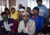 A group of non local labourers gather at Railway Station as they wait for train in Nowgam, Srinagar to go back to their native places on Monday. -Excelsior/Shakeel