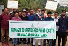Locals protesting against slow pace of work on Ramnagar-Basantgarh road.