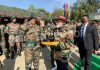 Prime Minister Narendra Modi offering sweets to jawans during his visit to an Army camp in Nowshera sector of Rajouri district. (UNI)