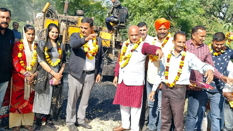 page5 DDC Chairman, Bharat Bushan kick starting blacktopping of road at Kalayanpur village on Saturday.