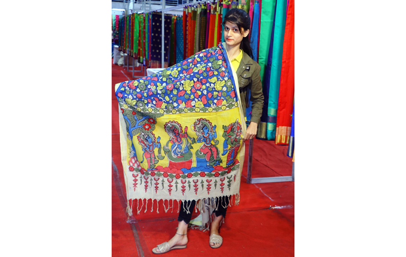 A woman displays Silk Saree at an exhibition in Jammu on Thursday.