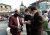 People being fined for not wearing face masks in Srinagar on Saturday.(UNI)