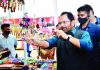 Union Minister of Minority Affairs Mukhtar Abbas Naqvi trying a slingshot during his visit to Hunar Haat at Vanita Vishram Parisar in Surat on Saturday. (UNI)