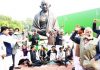 Opposition MPs raising slogans during a dharna in front of the Mahatma Gandhi statue in support of suspended MPs at Parliament house, in New Delhi on Monday. (UNI)