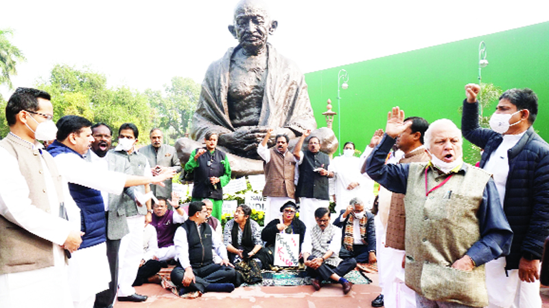 gandhi Opposition MPs raising slogans during a dharna in front of the Mahatma Gandhi statue in support of suspended MPs at Parliament house, in New Delhi on Monday. (UNI)