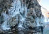 Visitors seen next to a frozen waterfall at Drug area of Baramulla district. — Excelsior/Aabid Nabi