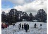 Tourists enjoy snowfall at Patnitop on Monday. -Excelsior/Parvaiz Mir