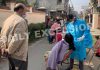 Health workers test people for COVID at Saraswati Vihar in Talab Tillo Jammu on Wednesday. The locality has been declared as micro-Containment Zone after detection of Omicron cases.