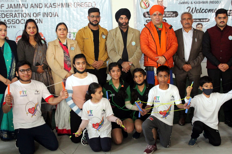 Participants of Rope Skipping event posing for a group photograph with J&K BJP president Ravinder Raina and others at Jammu.