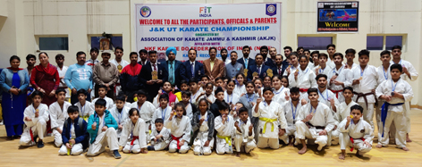 Winners displaying their medals while posing for a group photograph with dignitaries at Jammu.