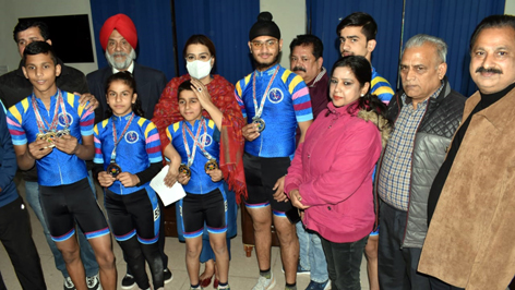 National medals winners displaying medals while posing with dignitaries at Jammu on Thursday.