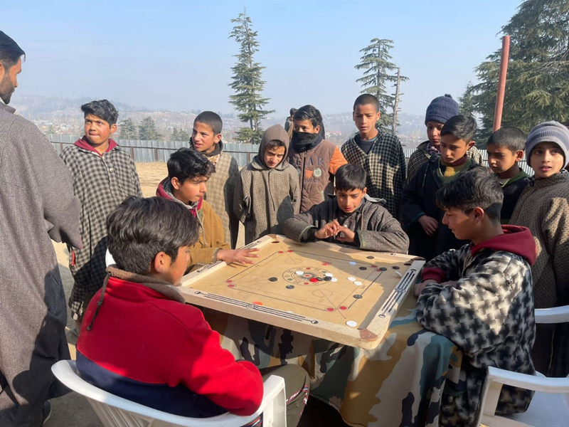 Children playing Carrom during the sports event in Baramulla.