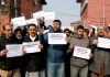 EJAC members staging protest demonstration at Press Enclave in Srinagar on Wednesday. —Excelsior / Shakeel