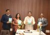 Union Education Minister Dharmendra Pradhan releasing a book translated by SMVDU faculty.