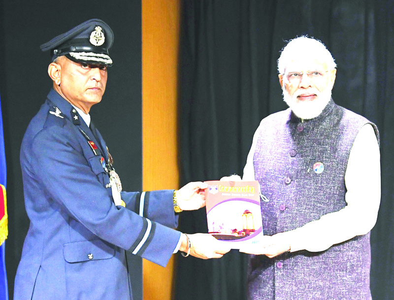 Prime Minister Narendra Modi being presented a publication on the occasion of Armed Forces Flag Day, in New Delhi on Tuesday. (UNI) Prime Minister Narendra Modi being presented a publication on the occasion of Armed Forces Flag Day, in New Delhi on Tuesday. (UNI)