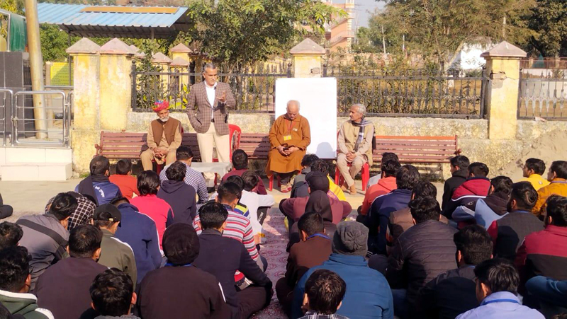 A speaker addressing a gathering at Bawa Kailakhdev Mandir during a programme organized by Sanskrit Bharti.