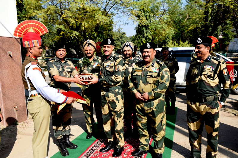 D K Boora, IG BSF, Jammu Frontier distributing sweets to BSF personnel to mark the Raising Day of the force in Jammu on Wednesday. (UNI)