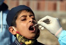 A boy being subjected to COVID test in Mendhar in Poonch district on Tuesday. — Excelsior/Rahi Kapoor