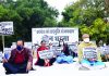 Delhi BJP leaders sitting on a dharna opposite Mahatma Gandhi Samadhi in protest against the breach of security in Prime Minister Narendra Modi's travel programme in Punjab, in New Delhi on Friday. (UNI)