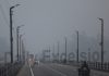 Vehicles move on Sidhra bridge during cold and foggy morning in Jammu on Thursday. —Excelsior/Rakesh