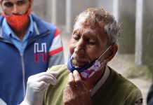 A Health worker collects nasal swab sample of a man for COVID-19 test in Poonch on Thursday. (UNI)