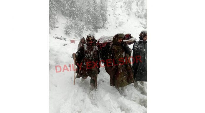 Army rescues an ailing woman at Ghaggar in Boniyar area of Uri. -ExcelsiorAbid Nabi