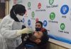 A Health worker takes a swab sample of JK Bank employee for Corona testing in Srinagar. —Excelsior/Shakeel