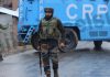 Troops stand guard at Okey village in Kulgam district during encounter on Tuesday. -Excelsior/Sajad Dar