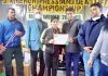 President J&K PYC Uday Bhanu Chib awarding a winner of Bench Press & Dead Lift Championship.