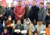 Winners displaying trophies while posing with chief guest, JMC Mayor Chander Mohan Gupta and others at Jammu.
