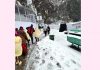 Pilgrims moving through fresh snowfall at Mata Vaishnodevi Bhawan on Saturday evening. -Excelsior/Karandeep