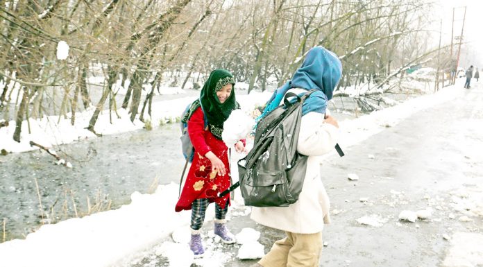 Children play with snow in the interiors of Dal lake on Thursday. - Excelsior/Shakeel