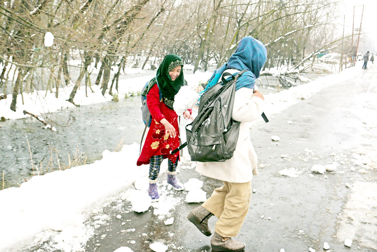 Children play with snow in the interiors of Dal lake on Thursday. - Excelsior/Shakeel Children play with snow in the interiors of Dal lake on Thursday. - Excelsior/Shakeel