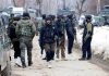 Security personnel near the site of encounter with militants at Nadigam area of Shopian district on Wednesday. (UNI)