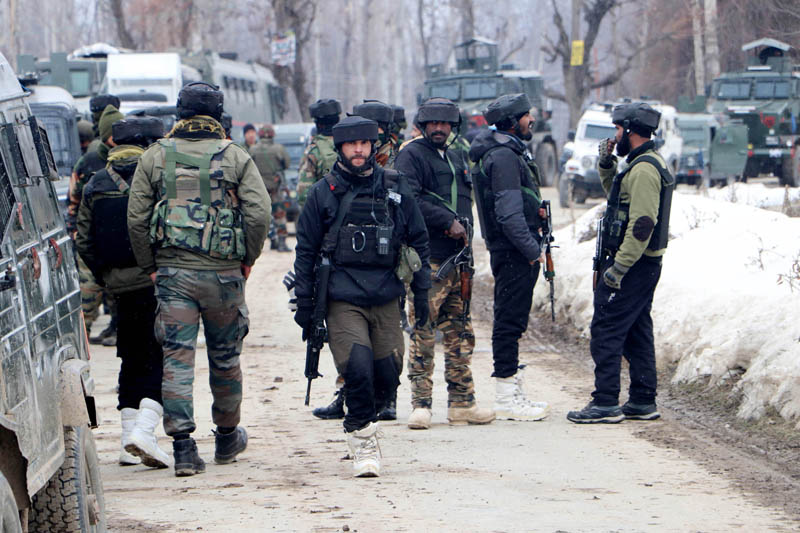 Security personnel near the site of encounter with militants at Nadigam area of Shopian district on Wednesday. (UNI)