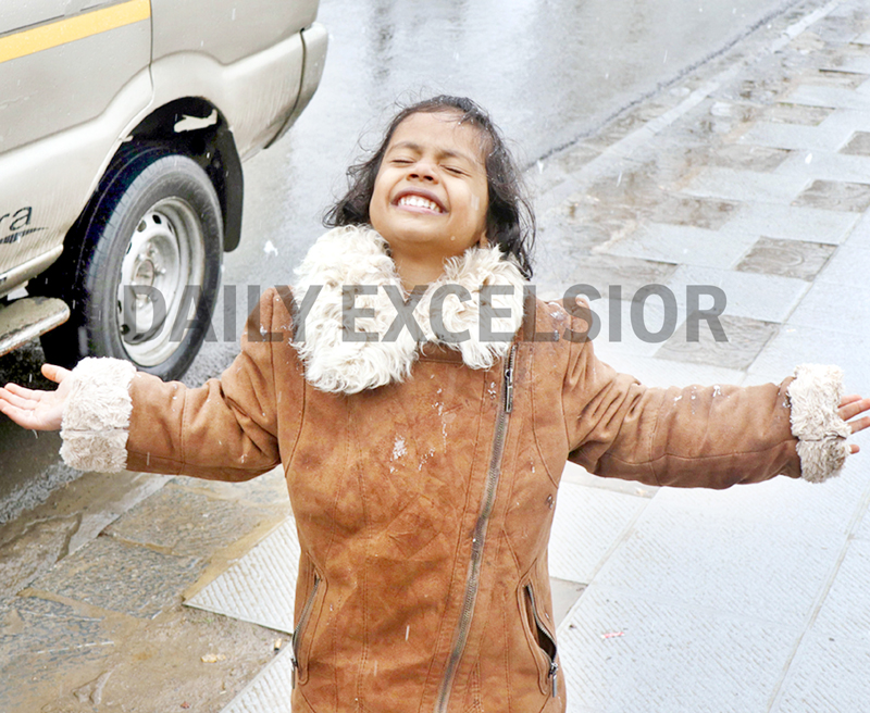 A child enjoys fresh snowfall in Srinagar on Tuesday. -Excelsior/Shakeel A child enjoys fresh snowfall in Srinagar on Tuesday. -Excelsior/Shakeel