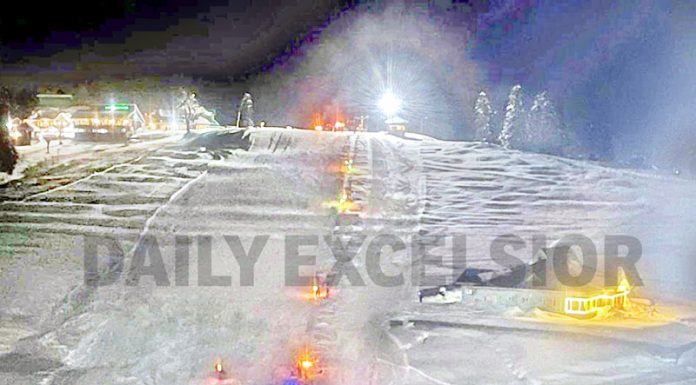 Tourists and locals holding torch lights enjoying night skiing on the slopes of a world-famous Ski resort in Gulmarg on Monday. (UNI)