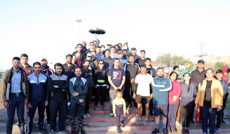 Participants of marathon posing for group photograph. Participants of marathon posing for group photograph.