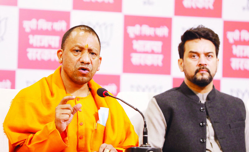 Uttar Pradesh Chief Minister Yogi Adityanath and Union Minister Anurag Thakur addressing a press conference at party office in Lucknow on Thursday. (UNI) Uttar Pradesh Chief Minister Yogi Adityanath and Union Minister Anurag Thakur addressing a press conference at party office in Lucknow on Thursday. (UNI)