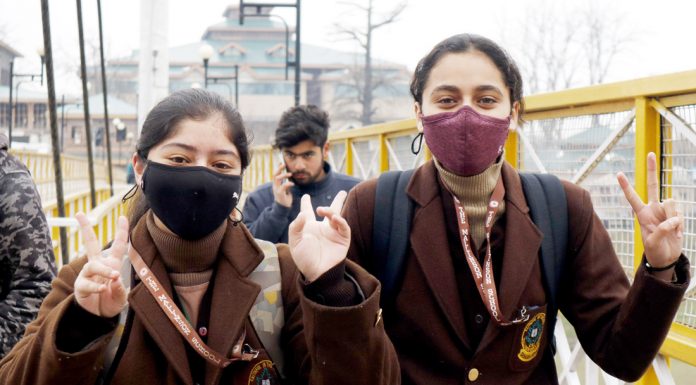 Jubilant students head towards their schools in Srinagar on Wednesday. —Excelsior/Shakeel