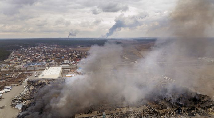 A factory and a store burning after been bombarded on Irpin, in the outskirts of Kyiv, Ukraine on Sunday.