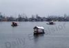 Shikaras move on Dal lake during a rainy day in Srinagar on Thursday. —Excelsior/Shakeel