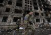 Ukrainian soldiers and firefighters search in a destroyed building after a bombing attack in Kyiv, Ukraine on Monday.