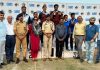 Winners displaying medals while posing with dignitaries at Jammu.