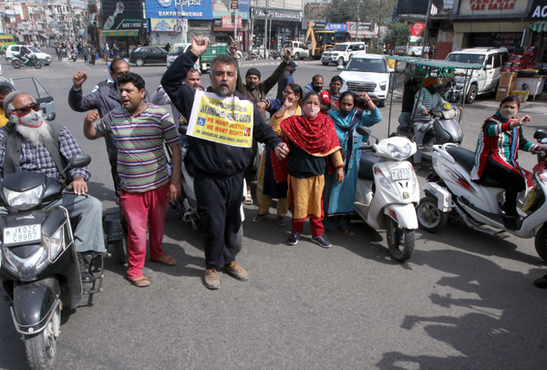 Members of J&K Handicapped Association raising slogans during protest rally at Dogra Chowk Jammu. -Excelsior/Rakesh Members of J&K Handicapped Association raising slogans during protest rally at Dogra Chowk Jammu. -Excelsior/Rakesh
