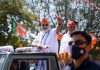 Prime Minister Narendra Modi flashing victory sign during the roadshow in Ahmedabad on Friday. (UNI)